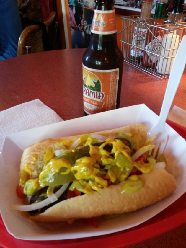 vegan chicago style hot dog and a bottle of Pyramid apricot ale